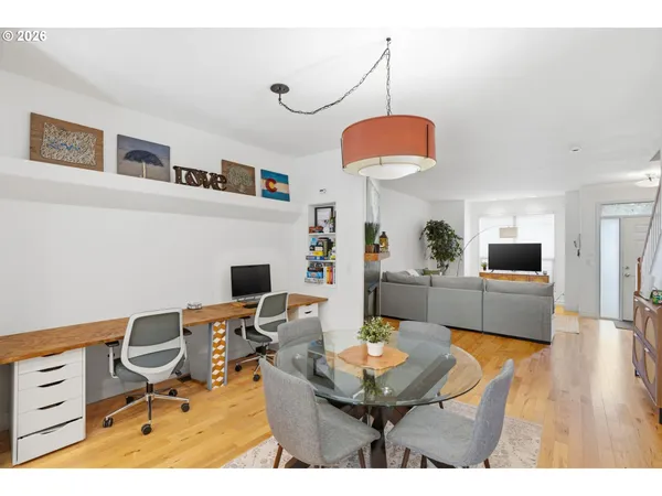 a living room with furniture a dining table and a fireplace