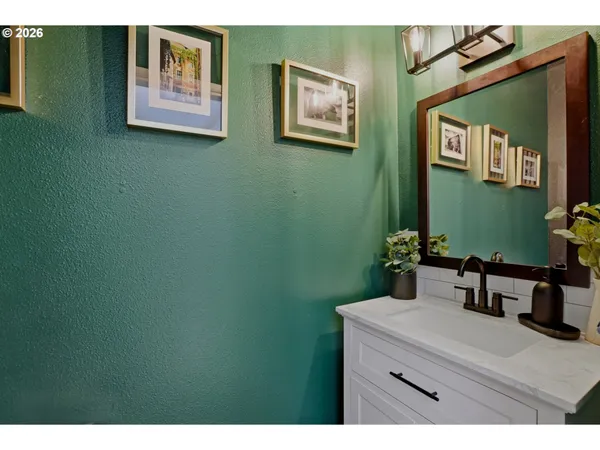 a view of an empty room and kitchen view