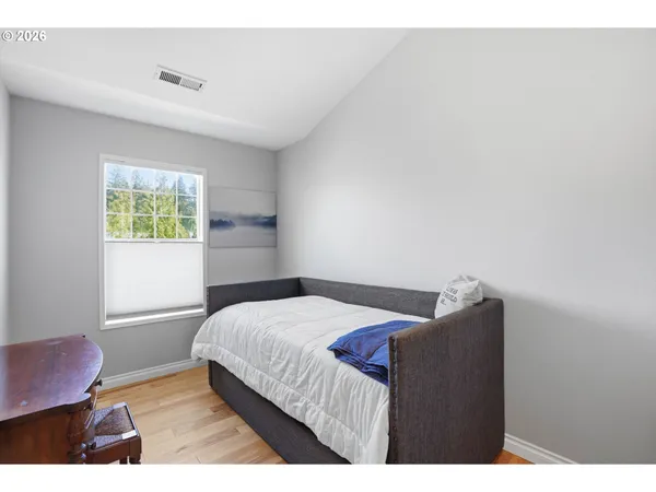 a bedroom with a bed and a large window