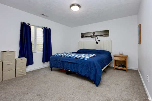 11751 Lake Run Road South Jordan, UT 84009 - Photo 30 of 38 Carpeted room featuring a window with window well, recessed ceiling light fixture, and white painted walls