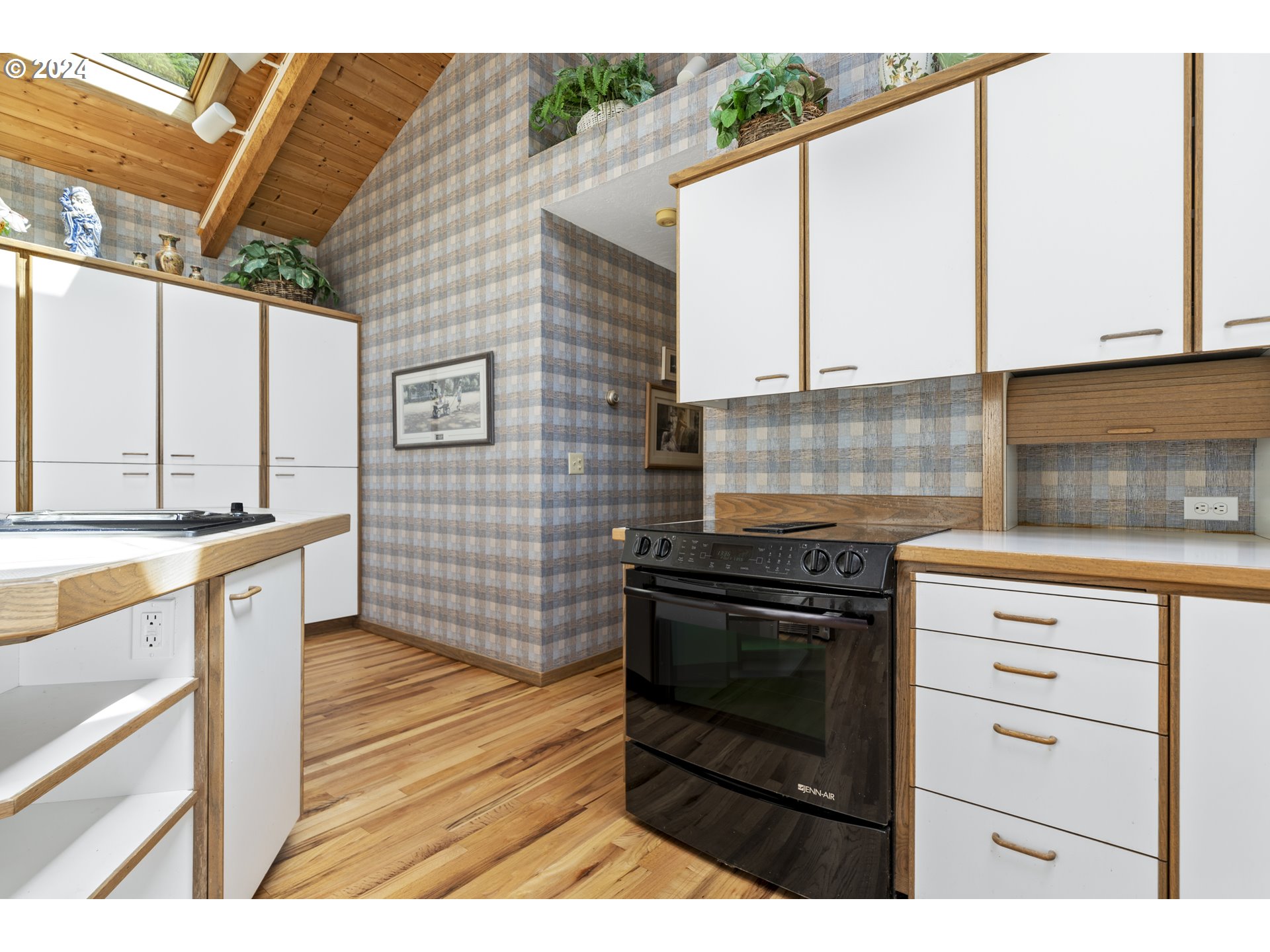 94515 Highway 101 Yachats, OR 97498 - Photo 18 of 45 a kitchen with stainless steel appliances kitchen island granite countertop a stove a sink and white cabinets