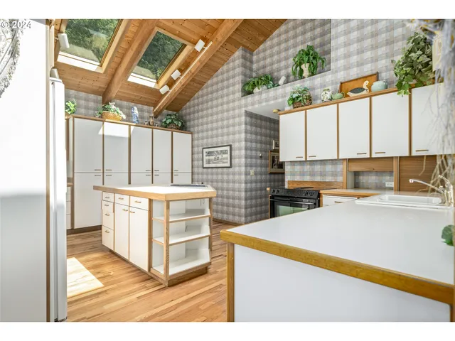 a kitchen with a sink a refrigerator and window