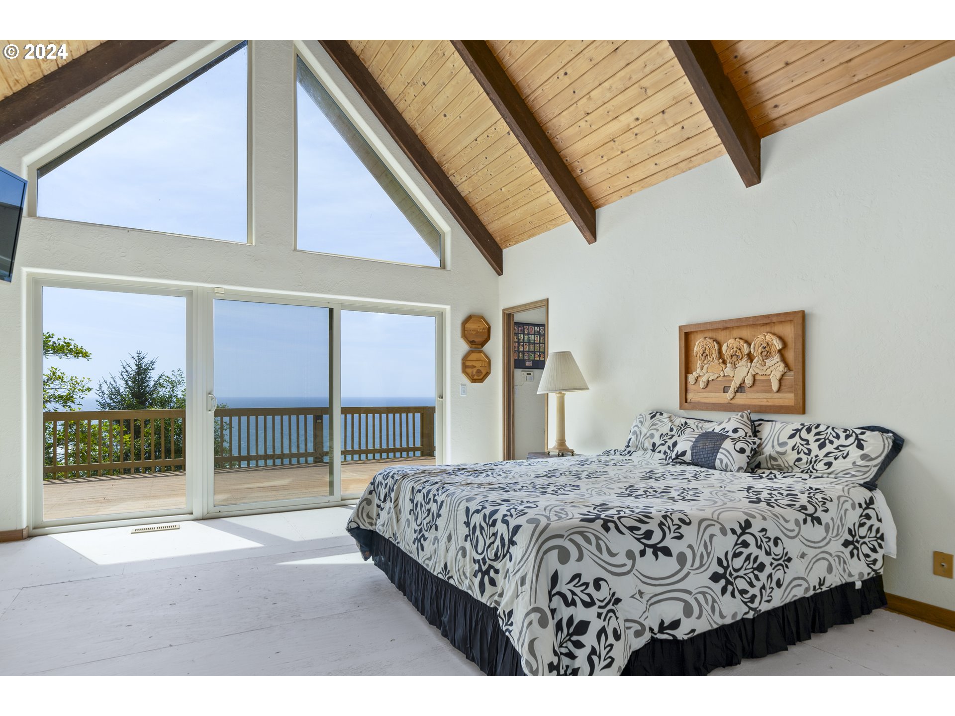 94515 Highway 101 Yachats, OR 97498 - Photo 24 of 45 a bedroom with a bed a dresser and next to a window