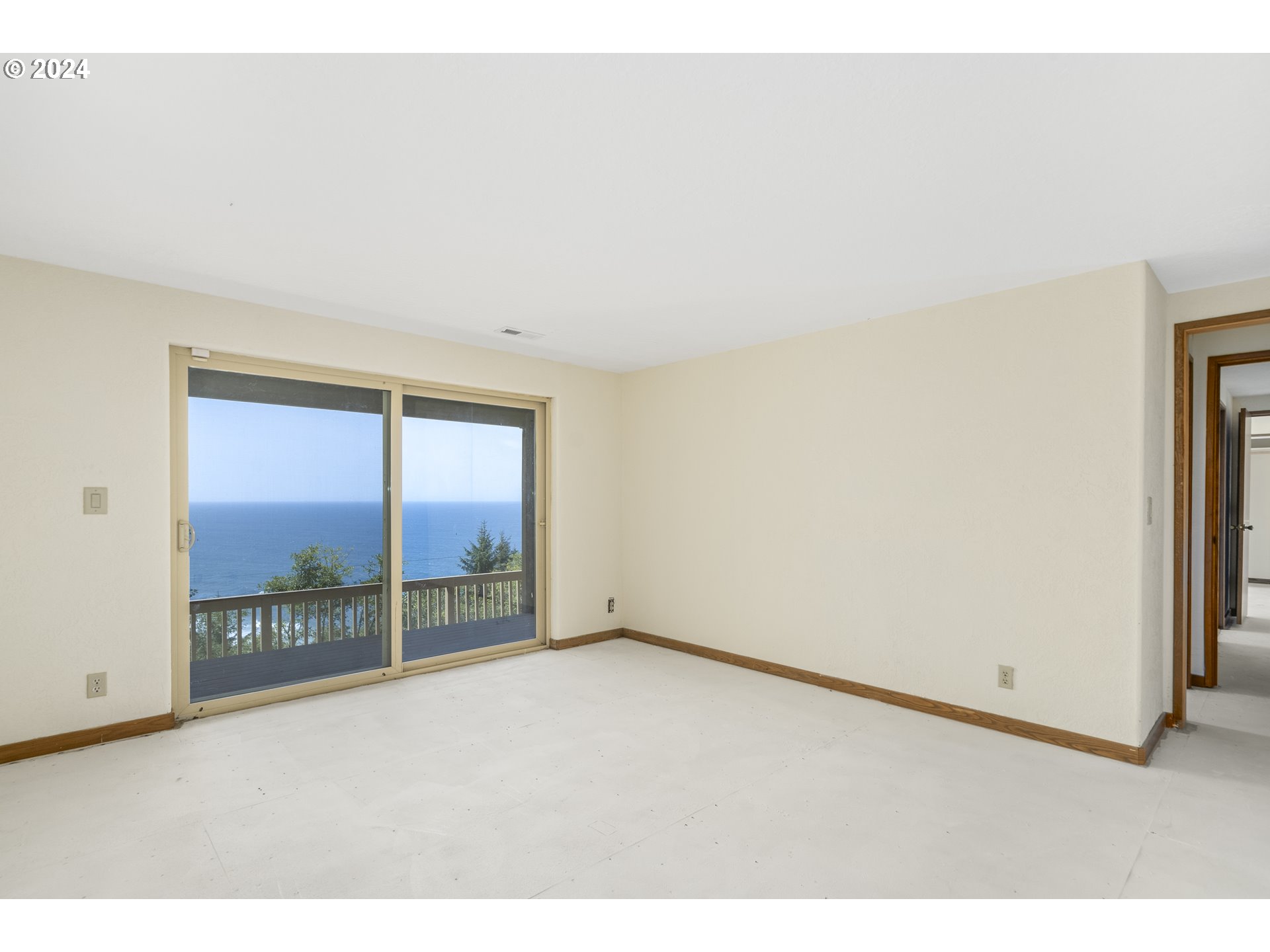 94515 Highway 101 Yachats, OR 97498 - Photo 38 of 45 an empty room with floor to ceiling windows