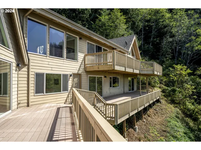 a view of backyard with wooden floor and fence