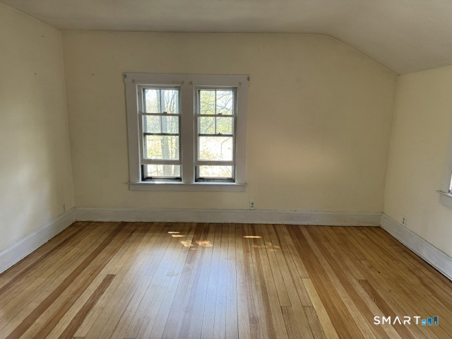 408 Huntington Road Scotland, CT 06264 - Photo 9 of 10 an empty room with wooden floor and windows
