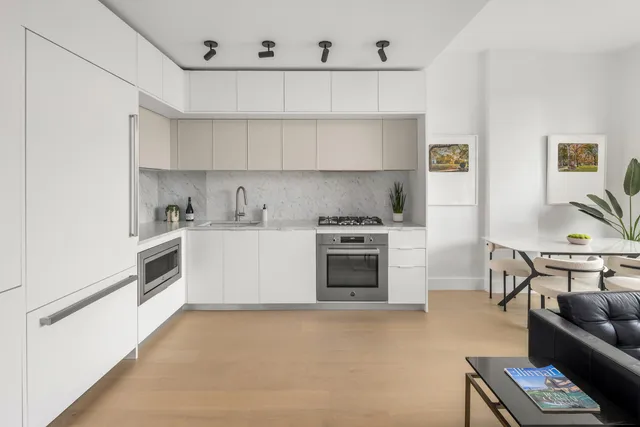 a kitchen with stainless steel appliances a stove a sink and a refrigerator