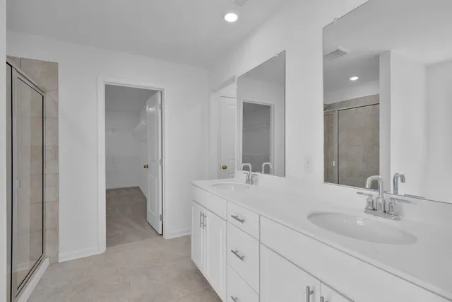 a bathroom with a double vanity sink and mirror