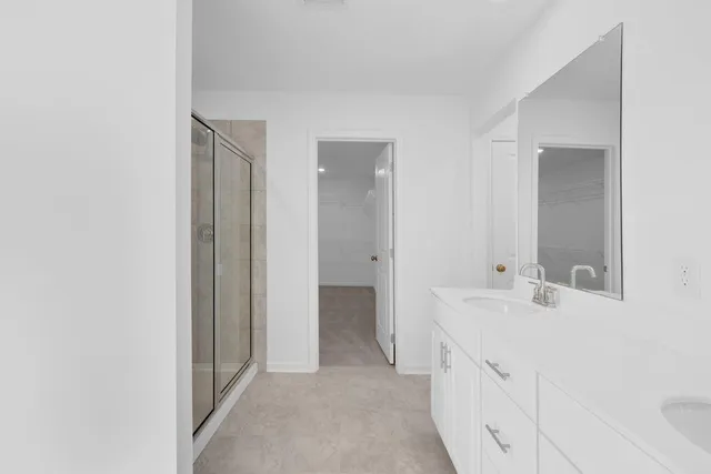 a bathroom with a shower and a sink