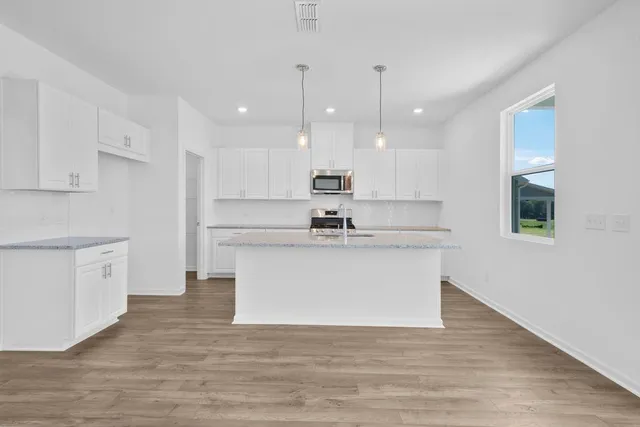 a view of a kitchen with a sink and microwave