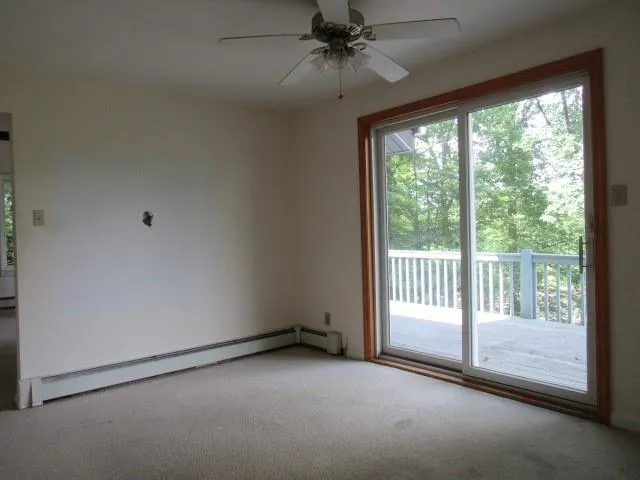 a view of an empty room and wooden floor