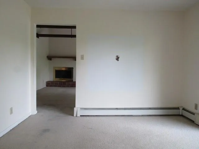 a view of an empty room with glass door