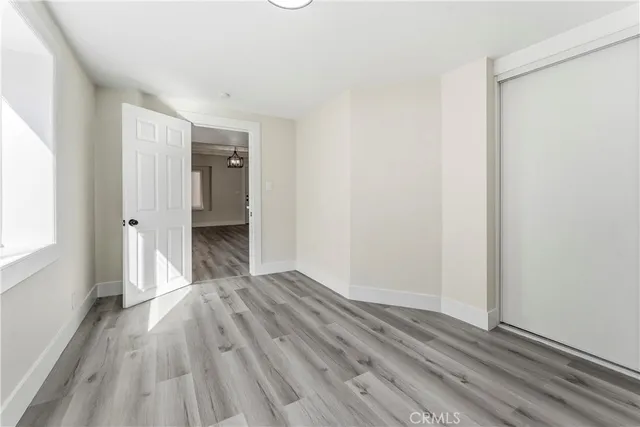 a view of a room with wooden floor and a window