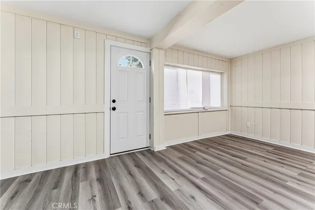 a view of empty room with wooden floor and cabinet