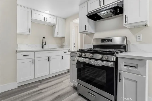 a kitchen with cabinets appliances and a sink