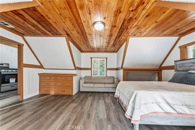 a room with wooden floor and furniture