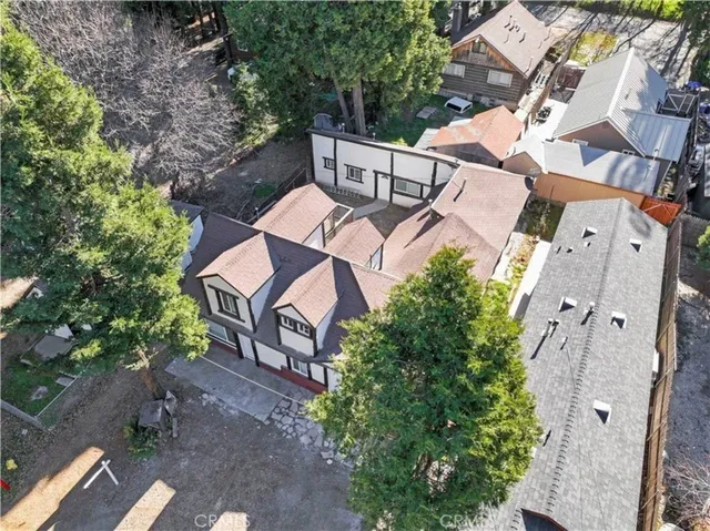 an aerial view of a house with a yard