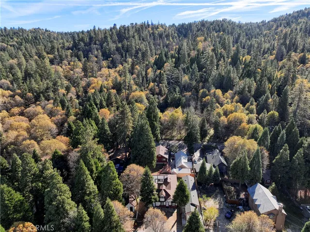 an aerial view of a house with swimming pool and outdoor space