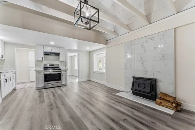a view of kitchen with sink microwave and stove top oven