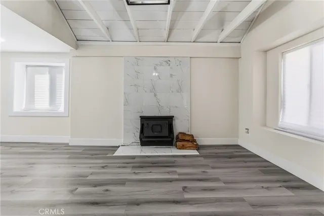 a view of a livingroom with wooden floor and a fireplace