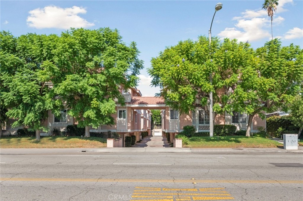 a front view of a house with a garden