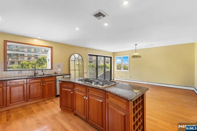 a kitchen with stainless steel appliances granite countertop a sink and cabinets