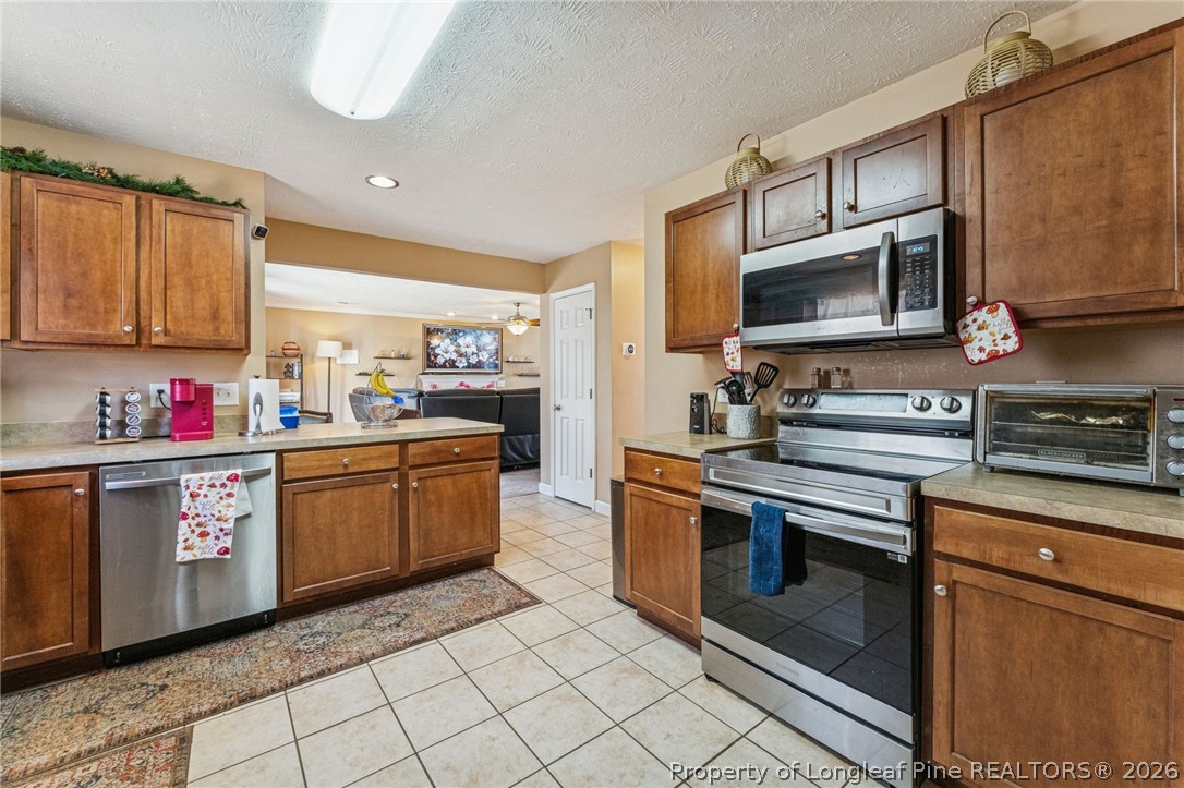 295 Pender Road Spring Lake, NC 28390 - Photo 11 of 30 a kitchen with stainless steel appliances granite countertop a stove sink microwave and cabinets
