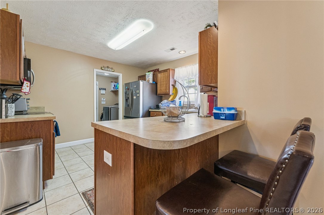 295 Pender Road Spring Lake, NC 28390 - Photo 12 of 30 a kitchen with a sink cabinets and a stove