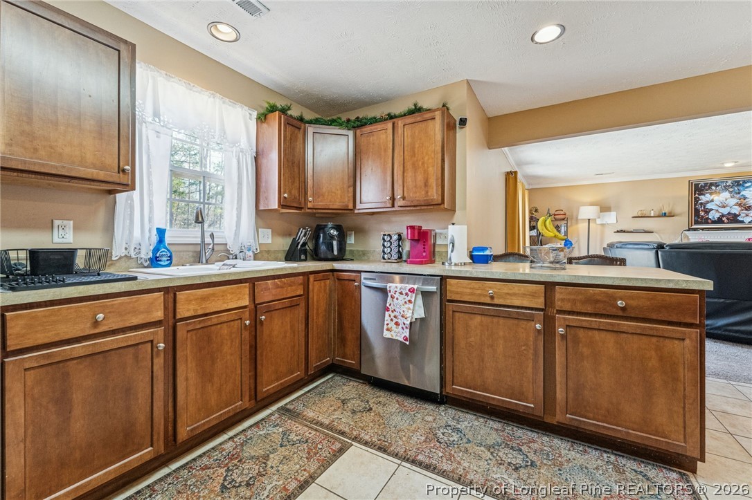295 Pender Road Spring Lake, NC 28390 - Photo 13 of 30 a kitchen with stainless steel appliances sink cabinets and window