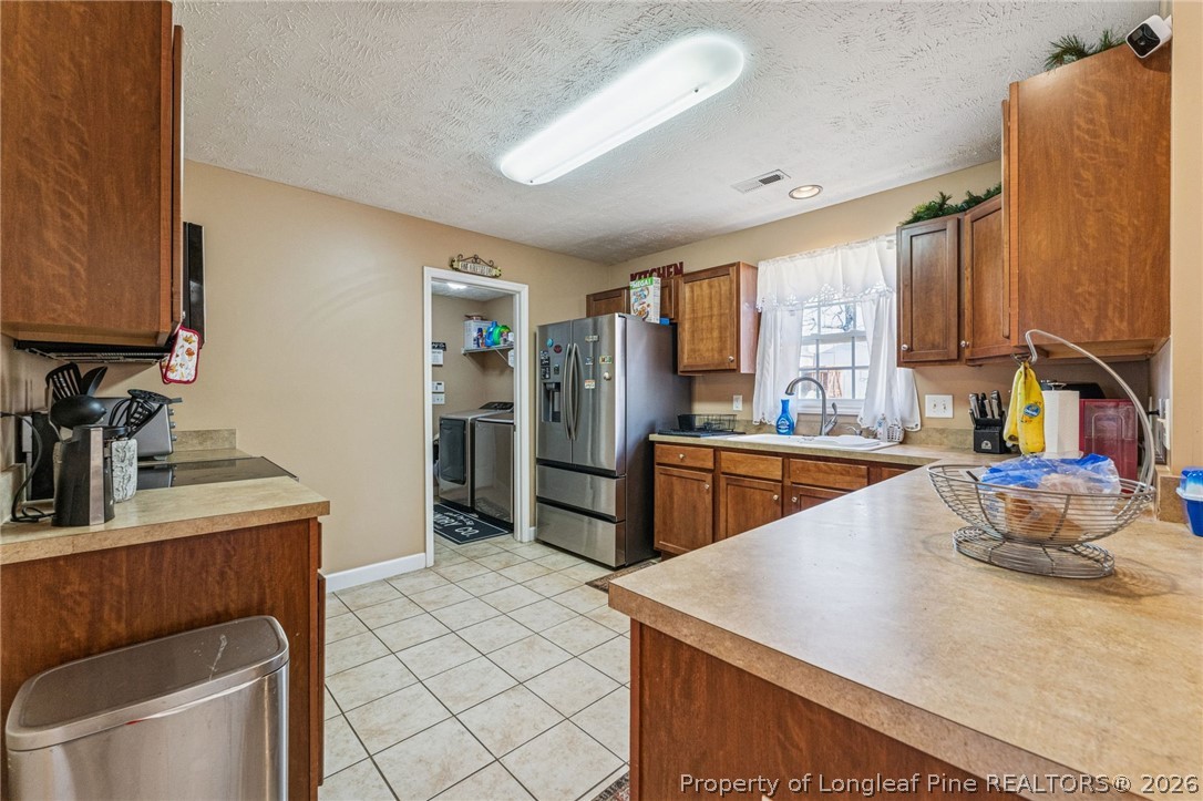 295 Pender Road Spring Lake, NC 28390 - Photo 14 of 30 a kitchen that has a sink and a stove in it