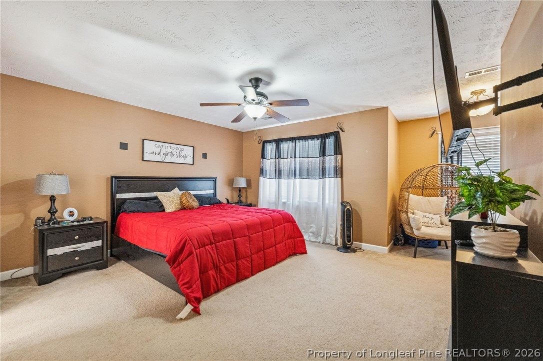 295 Pender Road Spring Lake, NC 28390 - Photo 19 of 30 a bed room with a bed and a potted plant