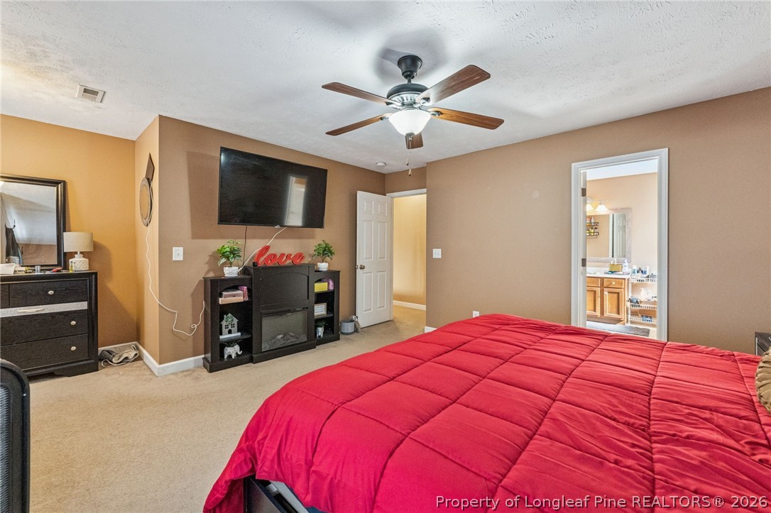 295 Pender Road Spring Lake, NC 28390 - Photo 20 of 30 a bedroom with a bed and a flat screen tv
