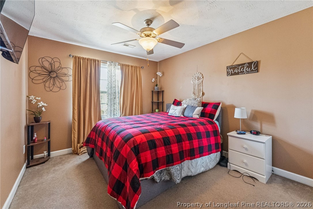 295 Pender Road Spring Lake, NC 28390 - Photo 25 of 30 a bed sitting in a bedroom next to a window