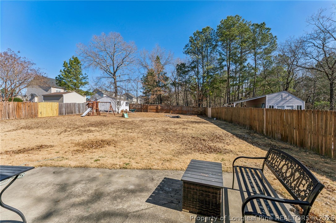 295 Pender Road Spring Lake, NC 28390 - Photo 4 of 30 a view of a backyard with wooden fence