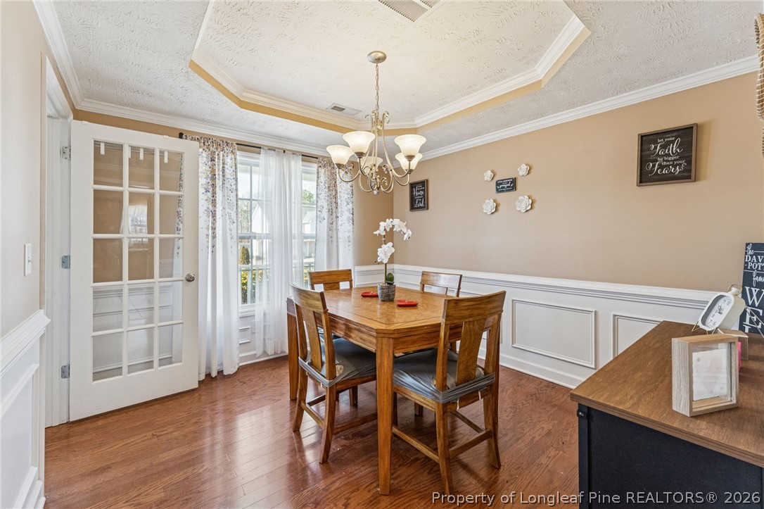 295 Pender Road Spring Lake, NC 28390 - Photo 8 of 30 a view of a dining room with furniture wooden floor and chandelier