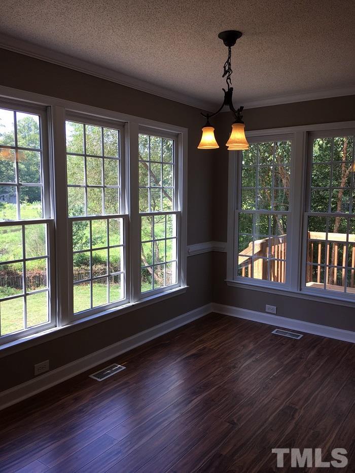 4100 Landrum Lane Raleigh, NC 27616 - Photo 12 of 12 a view of an empty room with wooden floor and a window