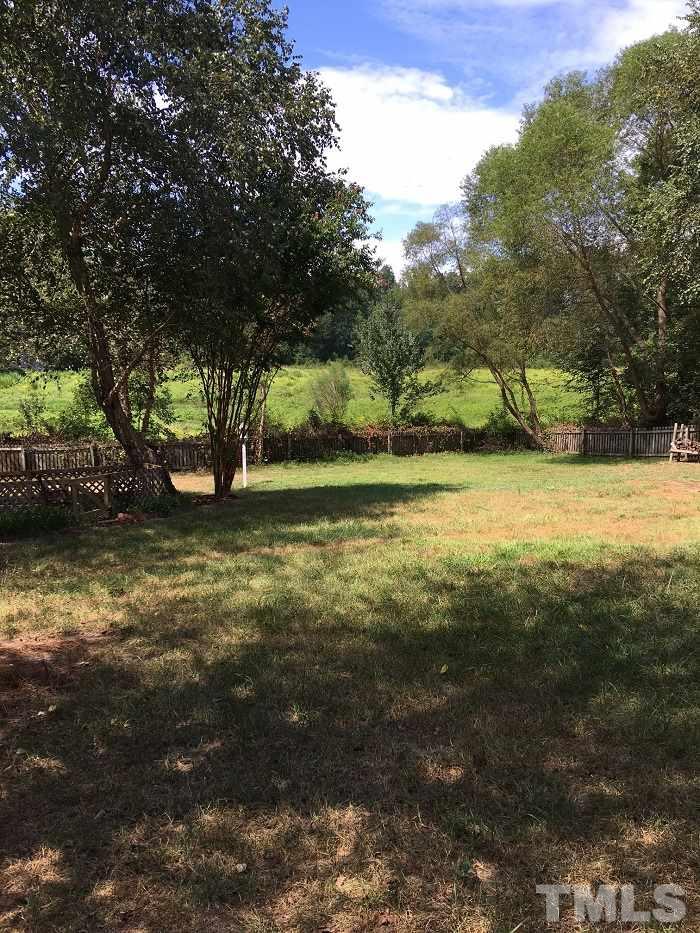 4100 Landrum Lane Raleigh, NC 27616 - Photo 7 of 12 a view of a yard with a tree