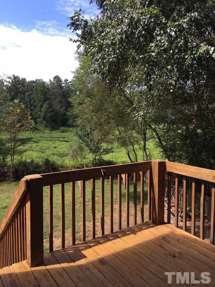4100 Landrum Lane Raleigh, NC 27616 - Photo 10 of 12 a balcony with wooden floor and fence