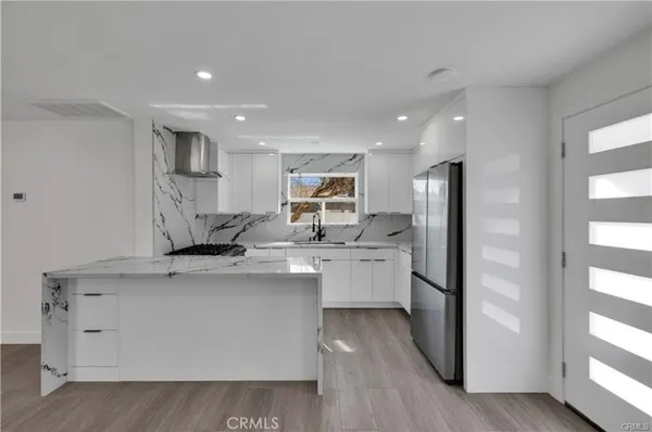 a kitchen with stainless steel appliances a refrigerator sink and microwave