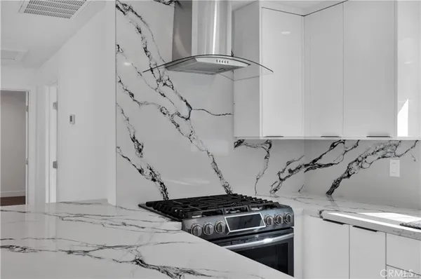 a close view of stove top oven and cabinets