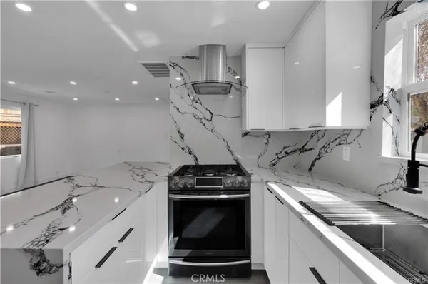 a kitchen with a sink appliances and cabinets