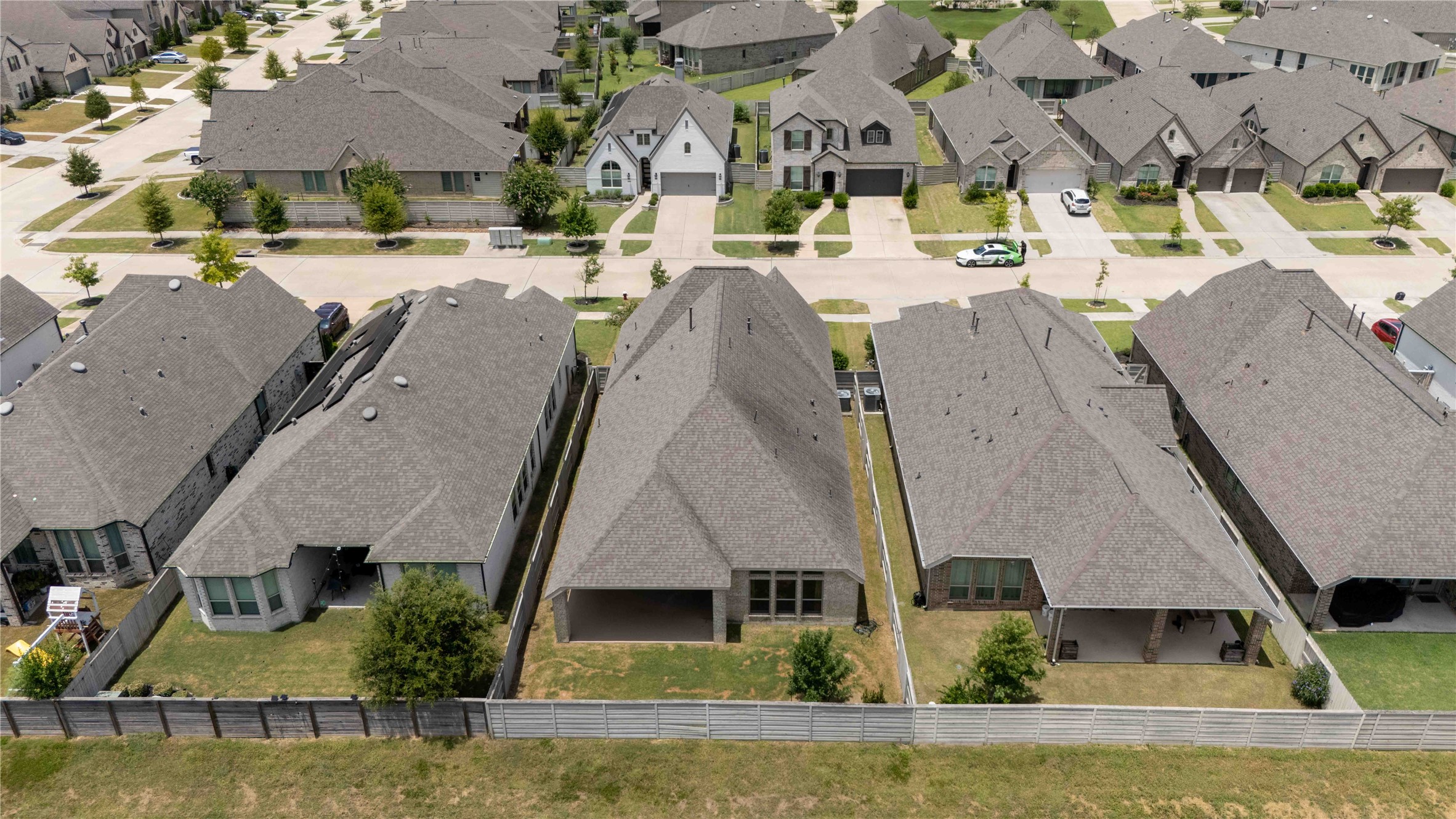 4333 Arbor Crest Lane Manvel, TX 77578 - Photo 35 of 40 This perspective highlights the rear elevation, the backyard dimensions, and the beautifully organized neighborhood grid beyond the property lines.