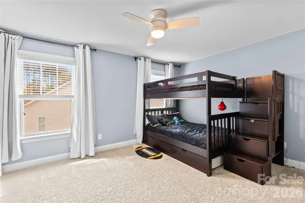 a bedroom with furniture and a window