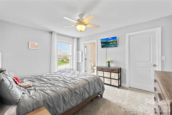 a bedroom with a bed and a chandelier