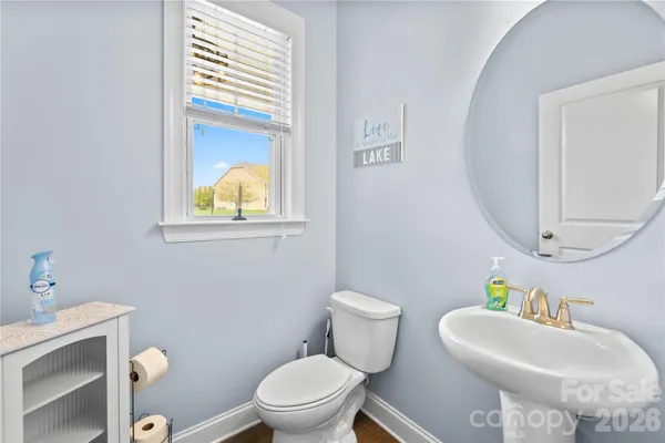 a bathroom with a toilet a sink and a mirror
