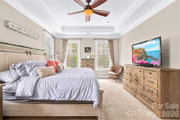 a bedroom with a bed and glass windows