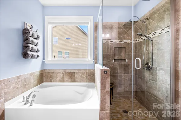 a white bath tub sitting next to a shower