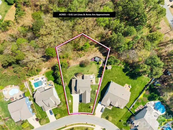 an aerial view of residential house with outdoor space and trees