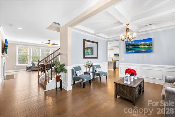 a living room with furniture dining table and wooden floor