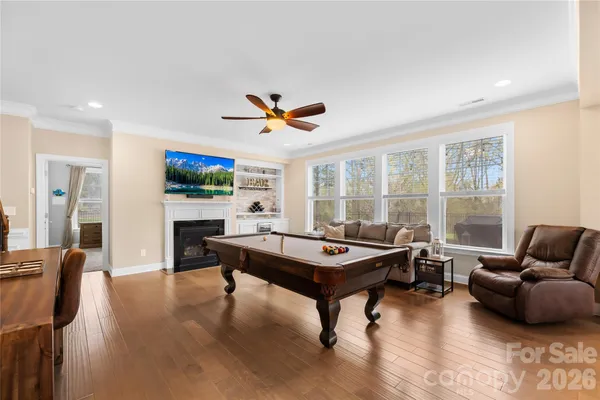 a living room with furniture a table and a large window